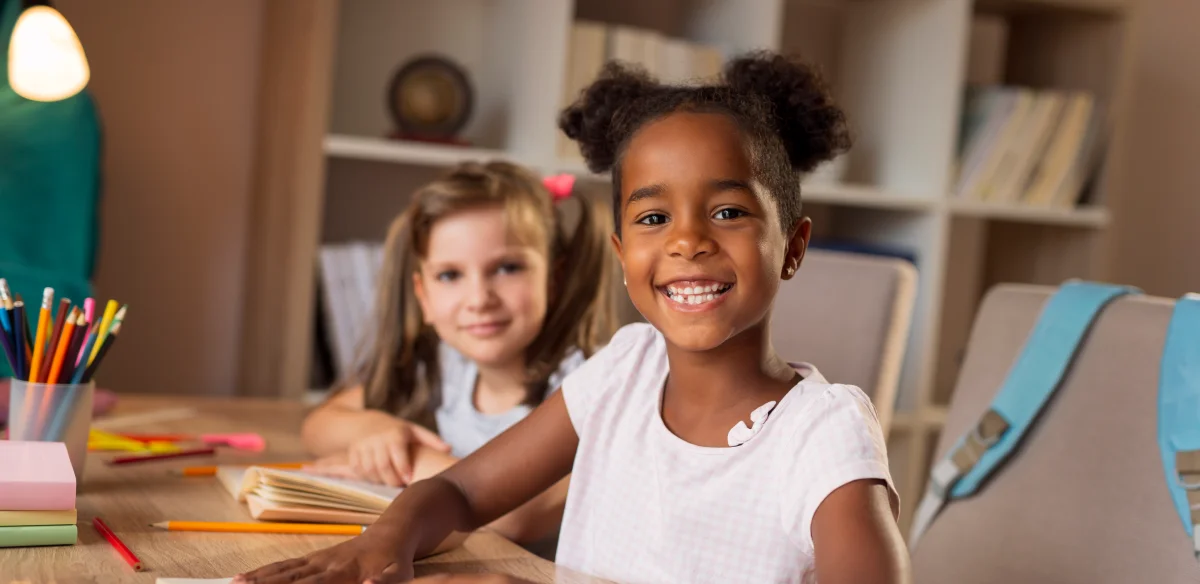 Two students smiling at the camera